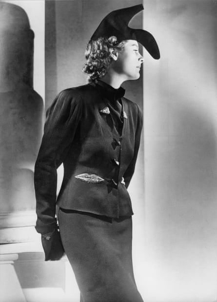 Woman wearing a hat shaped like a shoe, and jacket with an applique in the form of a lip, designed by Schiaparelli, 1937