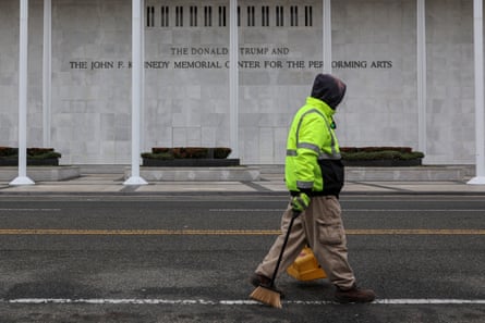 A worker walks past a building