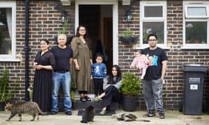 Zara Sehr (seated) with (l to r) Rubina, Arshad, Huraira, Imaan, Noor, Faisal and three of their cats.