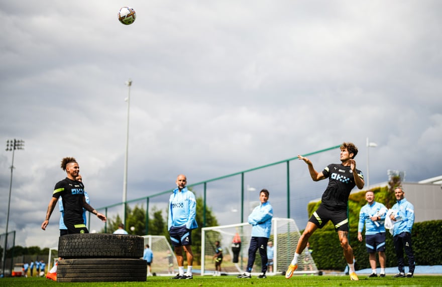 Manchester City new boy Kalvin Phillips and John Stones in pre-season training while Pep Guardiola looks on.