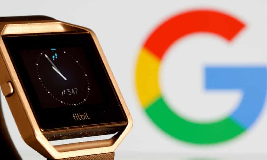 Fitbit watch next to Google logo