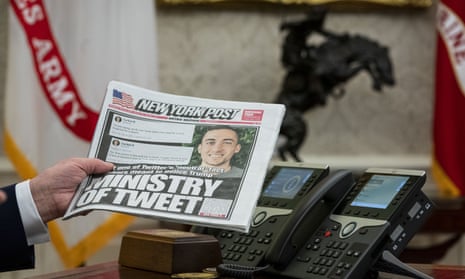 A copy of the New York Post is held up in the Oval Office in 2020.