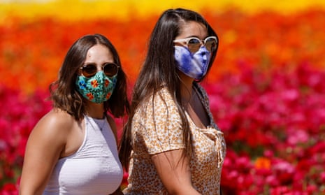 Women wear face masks and sunglasses outdoors in public. Some are reluctant to give up the face covering.