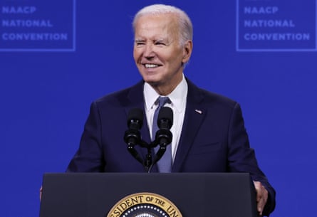 a man in a suit and tie speaks into a microphone