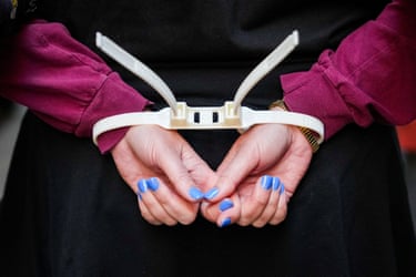 close up of handcuffed hands behind a person’s back