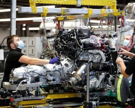 Technicians work on an engine on the production line of the Rolls-Royce Goodwood factory near Chichester