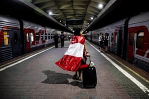 A woman with a Peruvian flag at Moscow’s Leningradsky station boards a train for Saint Petersburg.