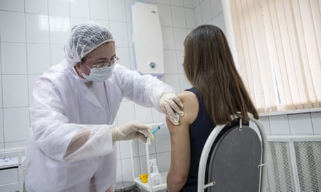 A medical worker inoculates a volunteer with “Sputnik V” during the Covid-19 vaccine phase-3 clinical trials in Moscow, Russia, on Tuesday.
