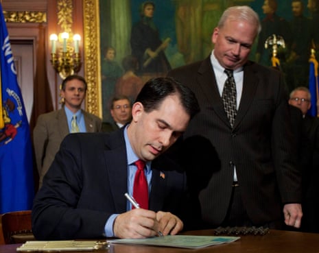 Wisconsin Governor Scott Walker signs a bill