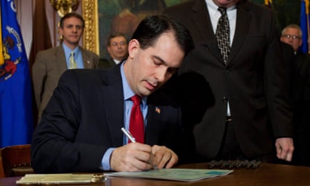 Governor Scott Walker signs a bill in Madison, Wisconsin in 2011. ‘Wisconsin was a testing ground for extreme Republican policies.’
