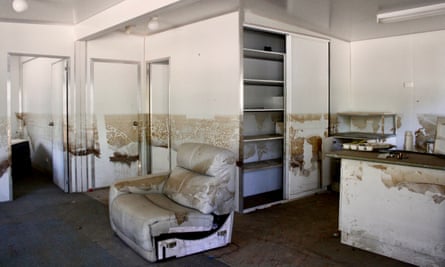 Inside one of the flooded cabins at McLean Beach holiday park showing the water mark about one metre up the wall and damaged furniture