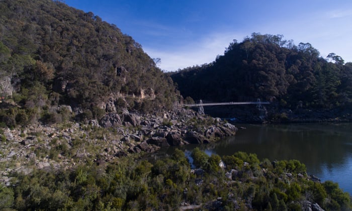 Landscape of Australian bush and a river with a bridge crossing