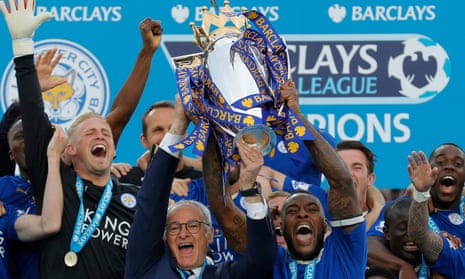 Leicester City captain Wes Morgan and manager Claudio Ranieri lift the trophy as the team celebrate.