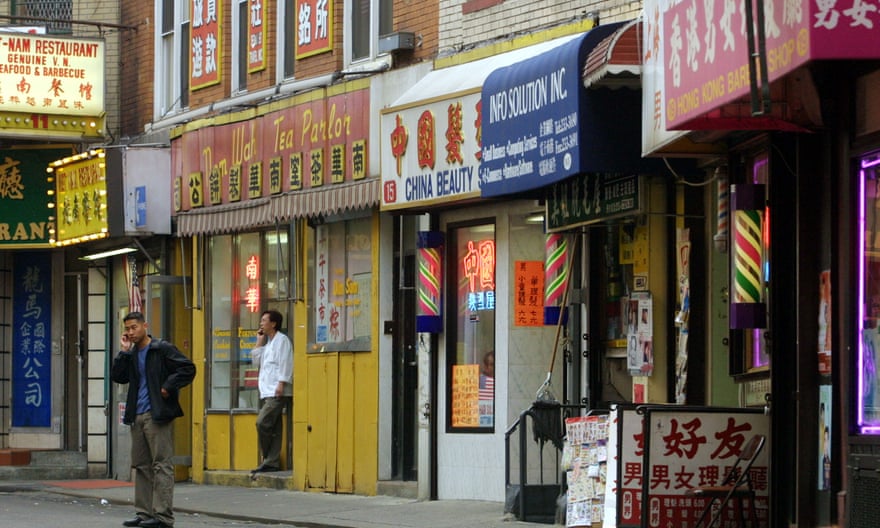 A man makes a cellphone call on an empty Chinatown street in November 2001.