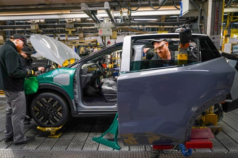 Workers assemble a Nissan Leaf electric vehicle on the production line at the Nissan Motor Company manufacturing plant in Sunderland.