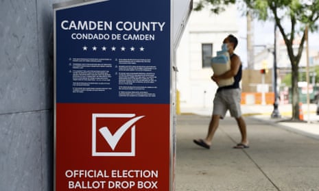 A man walks past a vote-by-mail drop box for the New Jersey primary election outside the Camden administration building.