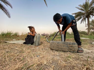 Abdul Hadi Mizher tries to draw water from a 16m deep well he drilled on this farm.