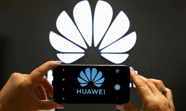A Huawei logo is seen on a smartphone