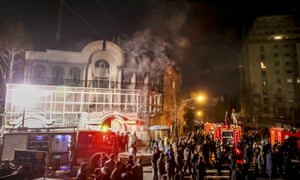 Smoke rises as Iranian protesters angry over the killing of Nimr al-Nimr set fire to the Saudi embassy in Tehran.