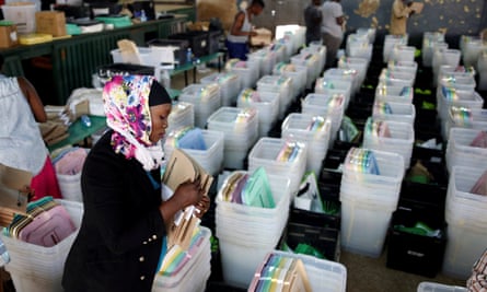 A Kenyan election officer in Nairobi prepares ballot boxes before they are transported to different polling stations.