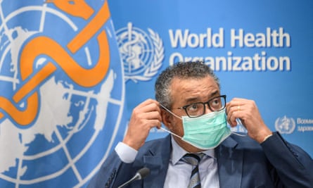 World Health Organization (WHO) Director-General Tedros Adhanom Ghebreyesus puts on a face mask during a press conference in Geneva