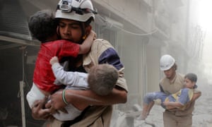 Members of the White Helmets rescue children after an airstrike in Aleppo