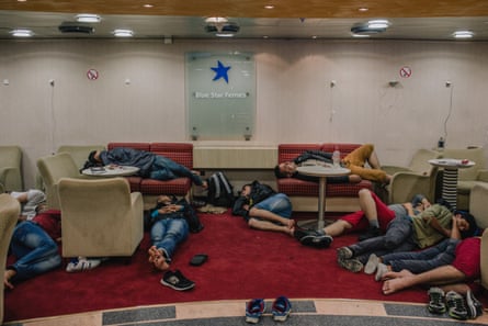 A group of refugees sleeping on chairs and on the floor aboard a ferry from Kastellorizo to Athens.
