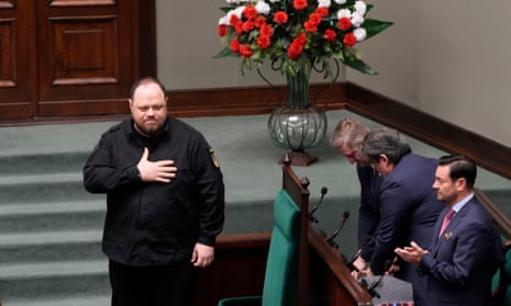 The chair of the Ukrainian parliament, Ruslan Stefanchuk, left, receives a warm welcome from Poland’s lawmakers ahead of his speech.
