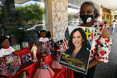 Island Dolls Company president Beverley Robatham-Reynolds poses with a poster congratulating US vice president Kamala Harris. Along with dolls and photos of Harris displayed at her street stall, in Kingston, Jamaica, 20 January 2021. EPA/Rudolph Brown