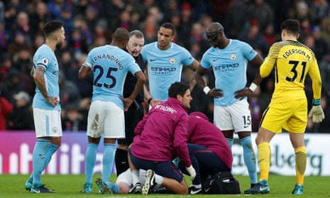 Manchester City players look on as Kevin De Bruyne receives treatment after a heavy challenge by Jason Puncheon, who only received a yellow card.