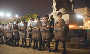 Police officers stand together in a line to alter the movement of demonstrators in Louisville, Kentucky, on 23 September.