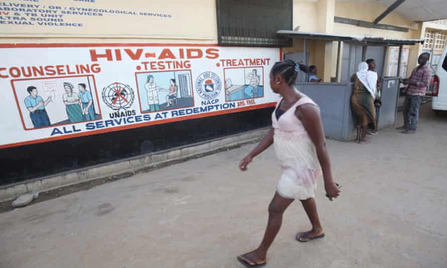 A woman looks at posters displaying information about HIV and Aids at a hospital in Liberia