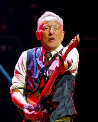 Bruce Springsteen performing on stage with guitar