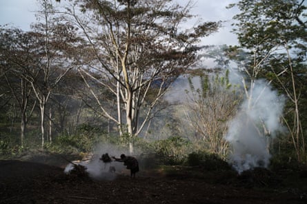 Ganiga women burn off leaves in front of Joe Leahy’s coffee plantation in preparation for his funeral