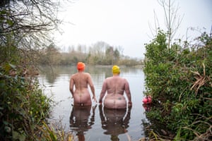 Two naked women about to go wild swimming, taken from behind
