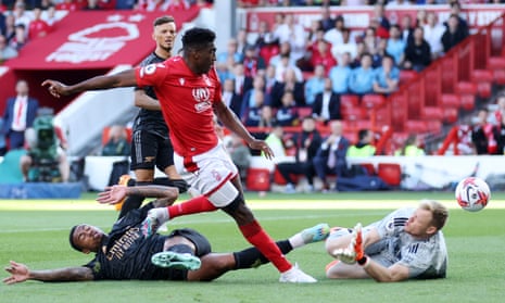 Taiwo Awoniyi dinks the ball over Arsenal keeper Aaron Ramsdale to give Nottingham Forest the lead.