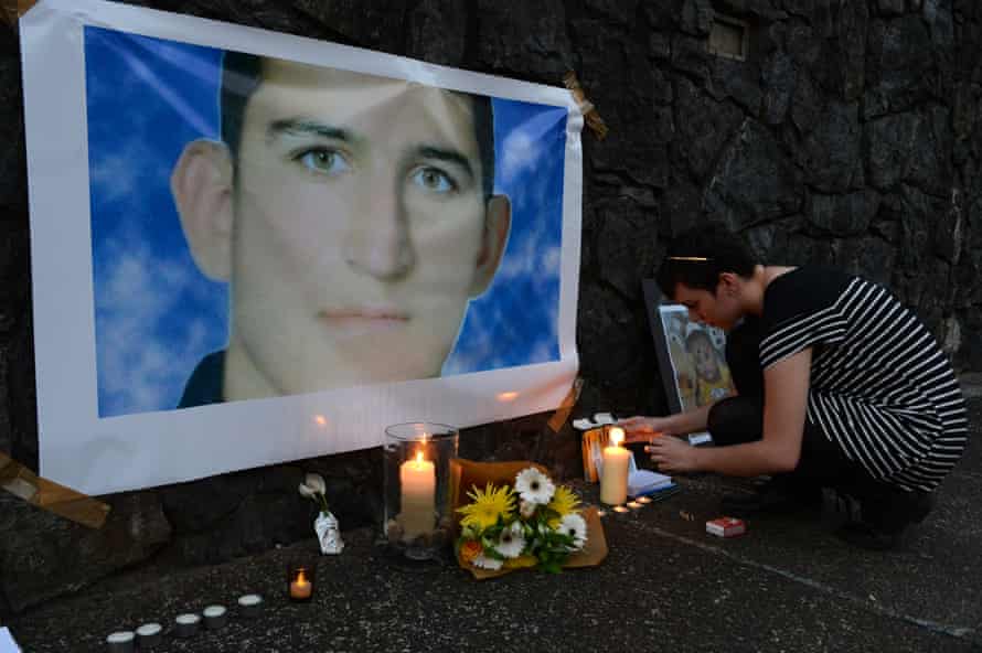 A woman lights a candle in a shrine for Reza Barati during a vigil in support of asylum seekers in Brisbane, Sunday, Feb. 23, 2014. The nation wide vigil was held in response to the death of 23-year-old Iranian man Reza Barati who died while in a detention centre on Manus Island on February 18.