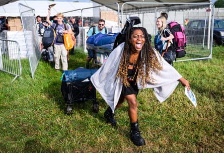 Festivalgoers pass through gates after the 8am public opening of the campsites on day one of the Glastonbury festival, 21 June