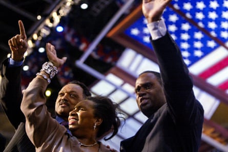 Three Black people wave to a crowd.