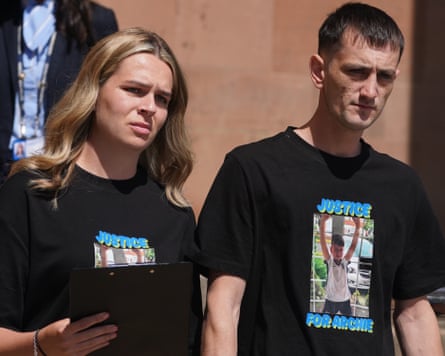 Katherine Errington and Robbie York outside court wearing T-shirts that say Justice for Archie