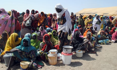Women and children wait for food at a refugee camp in Borno state, north-east Nigeria.
