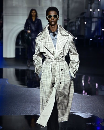 A model wearing a trenchcoat on the catwalk