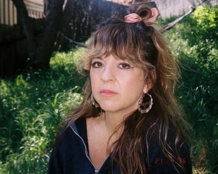 The musician Morgan Nagler sitting by grass