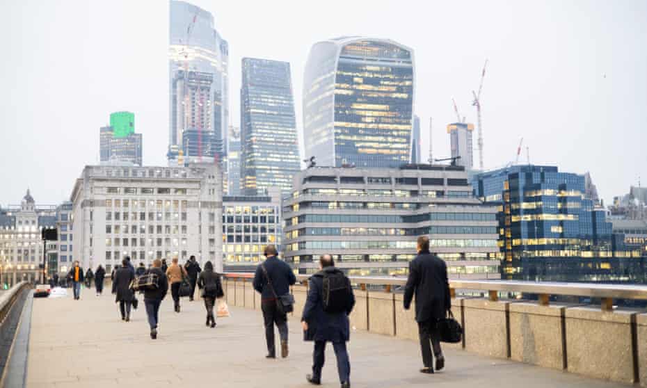 People walk to work over London Bridge to their offices