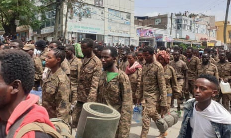 Ethiopian government soldiers and prisoners of war walk through the streets of Mekelle