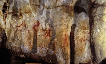 Paintings on a section of the La Pasiega cave wall, including a ladder shape composed of red horizontal and vertical lines.
