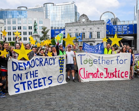 Activists holding signs and gold stars