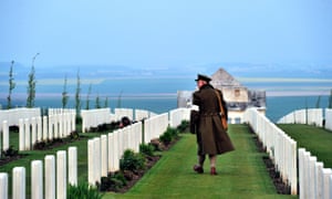 An Australian wearing an WWI uniform, walks past graves at the Australian War Memorial in the northern French city of Villers-Bretonneux.