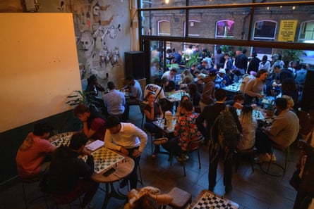 Overhead shot of people playing chess at individual tables.