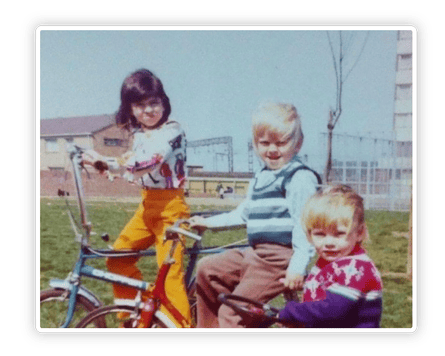 Old photo of young children on bikes